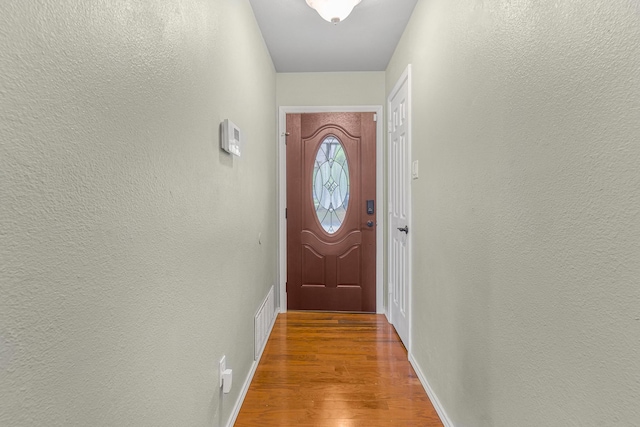 832 Ridgeview Dr, Burleson, TX 76028 - entryway with baseboards, visible vents, a textured wall, and wood finished floors