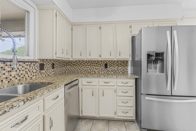 832 Ridgeview Dr, Burleson, TX 76028 - kitchen with light stone countertops, appliances with stainless steel finishes, a sink, light tile patterned floors, and tasteful backsplash