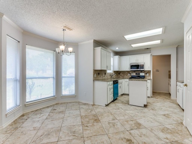 kitchen with decorative backsplash, a notable chandelier, stainless steel appliances, and plenty of natural light