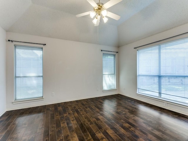 unfurnished room with lofted ceiling, a healthy amount of sunlight, ceiling fan, and hardwood / wood-style floors