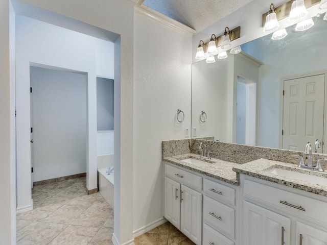 bathroom featuring a bath, double vanity, a sink, and baseboards