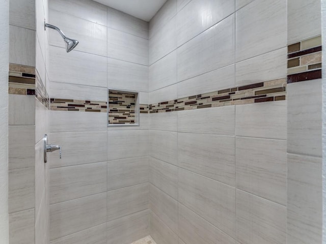 full bath with a tile shower