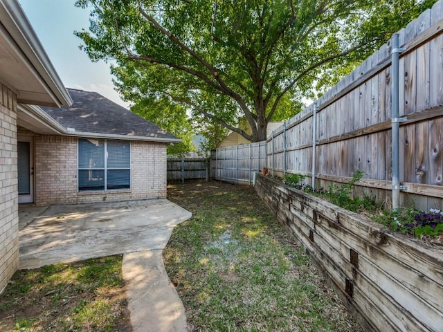 view of yard with a fenced backyard and a patio area