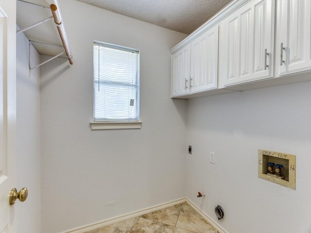 washroom with light tile patterned floors, cabinet space, hookup for a gas dryer, washer hookup, and baseboards