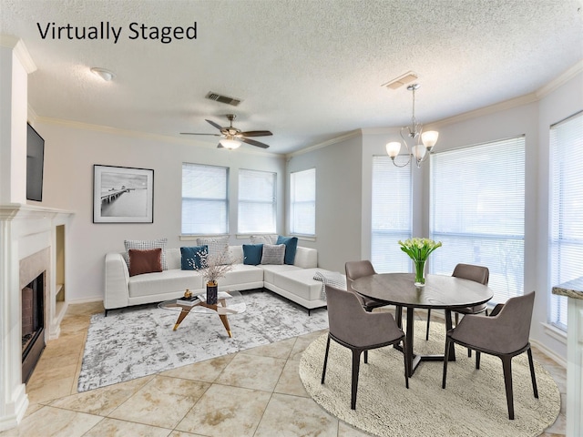 living area with crown molding, visible vents, and a healthy amount of sunlight