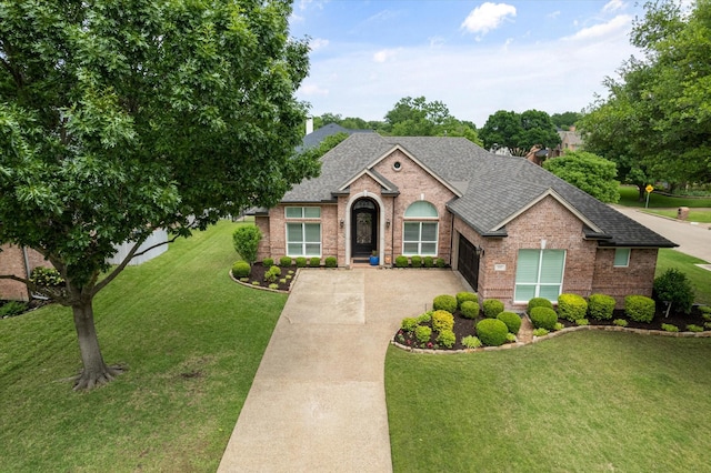 view of front of home featuring concrete driveway, roof with shingles, a front lawn, and brick siding