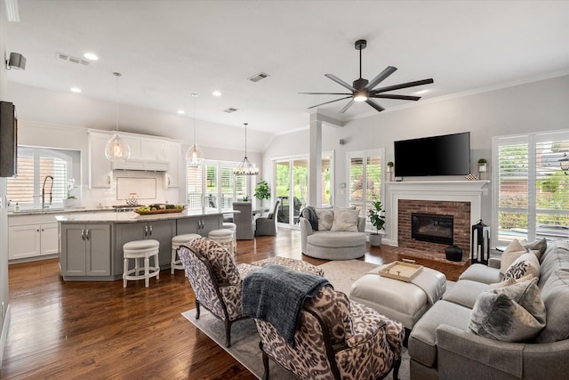 living room with a fireplace, visible vents, ceiling fan, and dark wood-type flooring