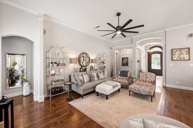 living area with decorative columns, arched walkways, a ceiling fan, and wood finished floors