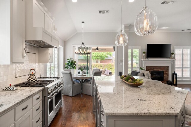 kitchen with double oven range, open floor plan, visible vents, and dark wood-style flooring