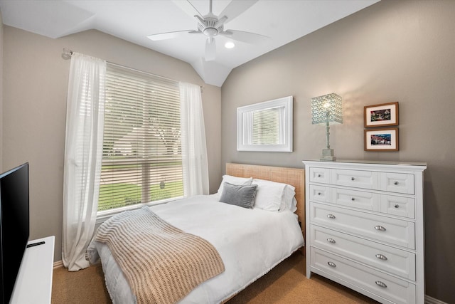 bedroom featuring a ceiling fan, carpet floors, multiple windows, and lofted ceiling