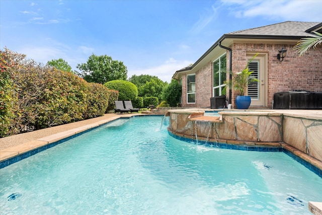 outdoor pool featuring a jacuzzi