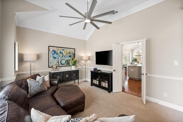 living room featuring carpet, vaulted ceiling, ceiling fan with notable chandelier, baseboards, and crown molding