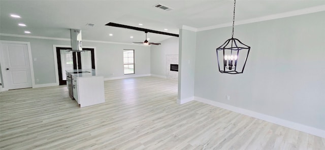 kitchen featuring ornamental molding, open floor plan, and light wood-style floors