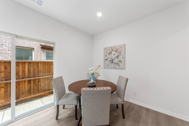 dining room with visible vents, recessed lighting, baseboards, and wood finished floors