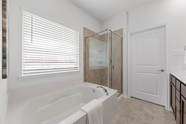 full bath with vanity, tile patterned floors, a bath, and a stall shower
