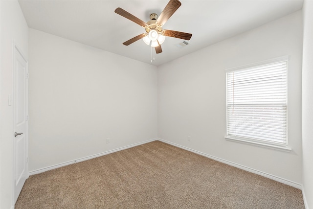 unfurnished room featuring carpet floors, a ceiling fan, and baseboards