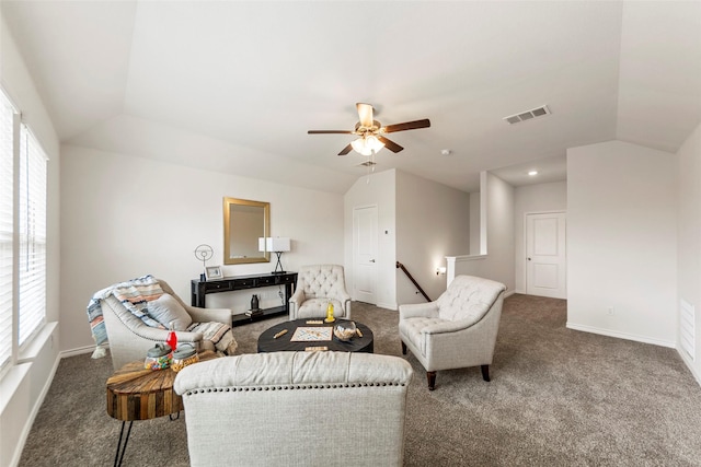 carpeted living area featuring a ceiling fan, baseboards, visible vents, and lofted ceiling