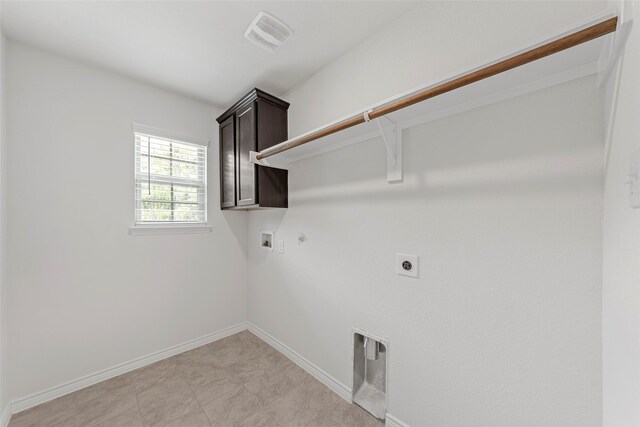 clothes washing area featuring gas dryer hookup, hookup for an electric dryer, washer hookup, cabinet space, and baseboards