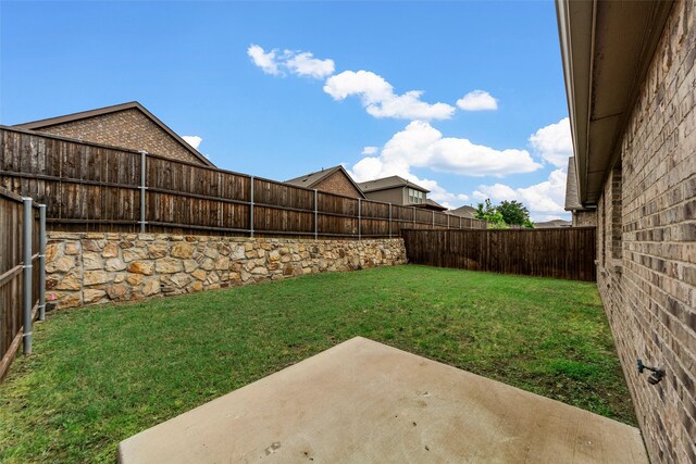 view of yard with a fenced backyard and a patio area