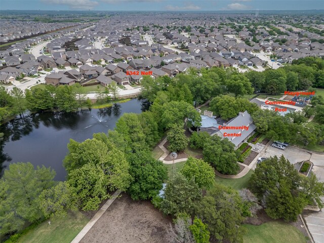 bird's eye view featuring a water view and a residential view