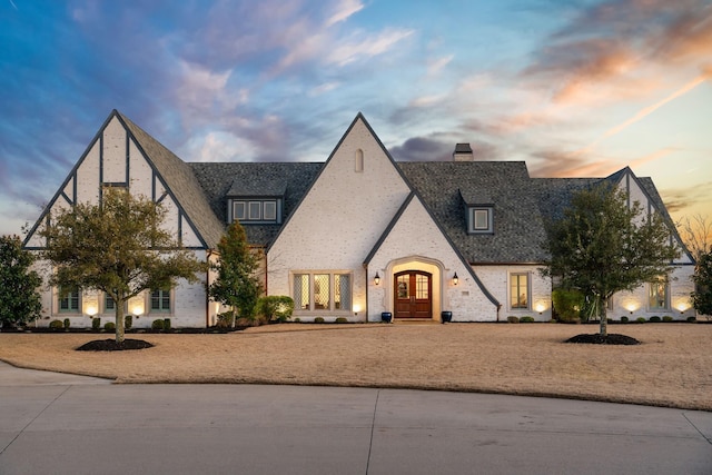 4260 Tranquility Ln, Prosper, TX 75078 - tudor house with a chimney and french doors