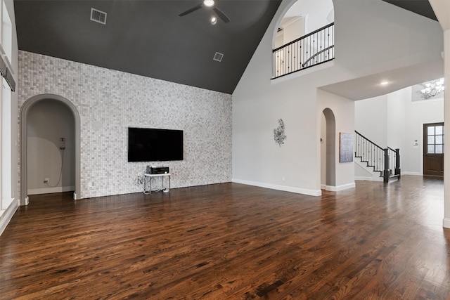 3404 Ophel Way, Flower Mound, TX 75028 - unfurnished living room with arched walkways, high vaulted ceiling, ceiling fan with notable chandelier, stairs, and visible vents