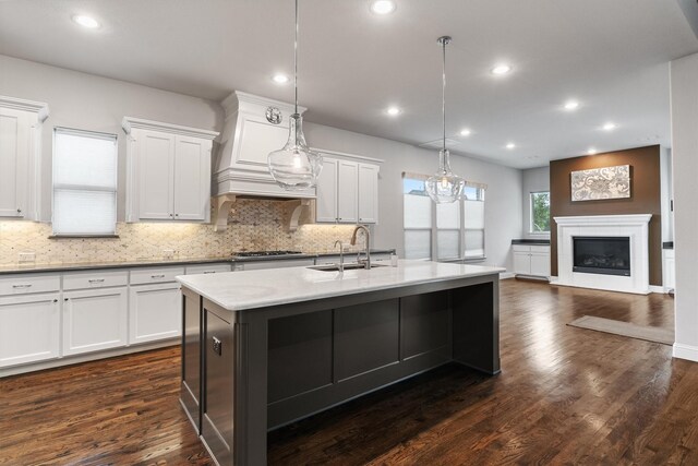 3404 Ophel Way, Flower Mound, TX 75028 - kitchen with stainless steel gas cooktop, a center island with sink, a sink, and tasteful backsplash