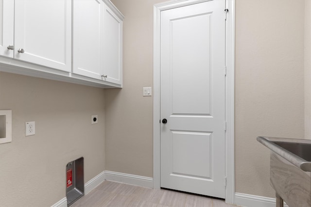 3404 Ophel Way, Flower Mound, TX 75028 - clothes washing area with baseboards, electric dryer hookup, and cabinet space