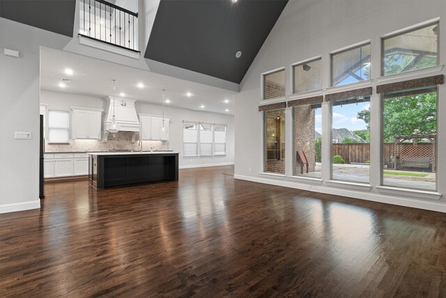 3404 Ophel Way, Flower Mound, TX 75028 - unfurnished living room with baseboards, dark wood-style floors, and high vaulted ceiling