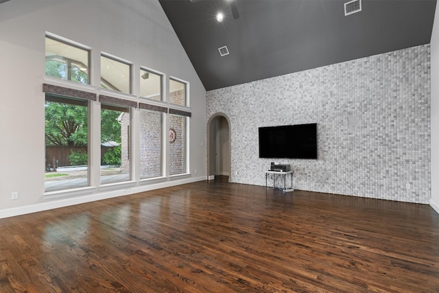 3404 Ophel Way, Flower Mound, TX 75028 - unfurnished living room featuring arched walkways, high vaulted ceiling, visible vents, and wood finished floors