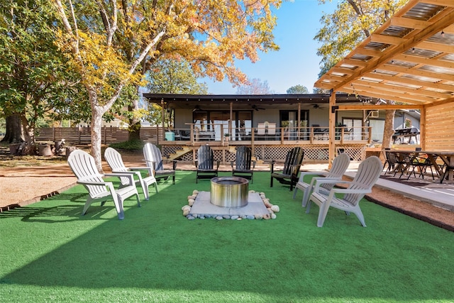 exterior space featuring fence, a pergola, a deck, a ceiling fan, and a fire pit