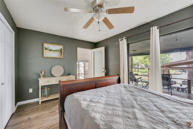 bedroom with wood finished floors, a ceiling fan, access to exterior, a closet, and a textured ceiling