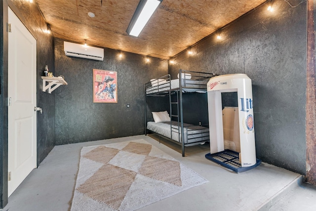 bedroom featuring concrete flooring and a wall mounted AC