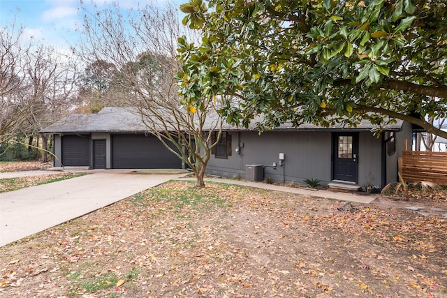 ranch-style home with concrete driveway and a garage