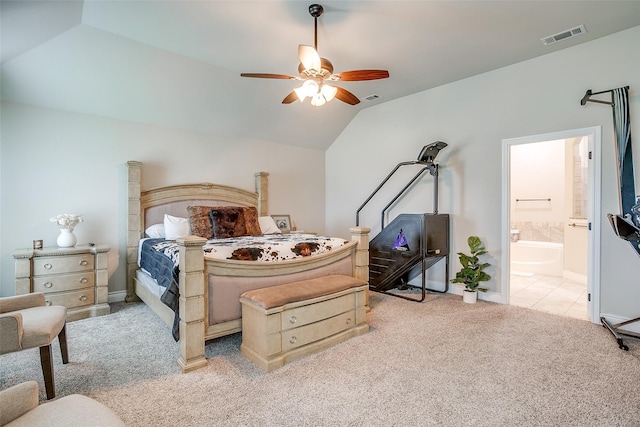 bedroom featuring ensuite bath, light carpet, baseboards, visible vents, and lofted ceiling