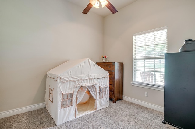 bedroom with lofted ceiling, carpet, a ceiling fan, and baseboards