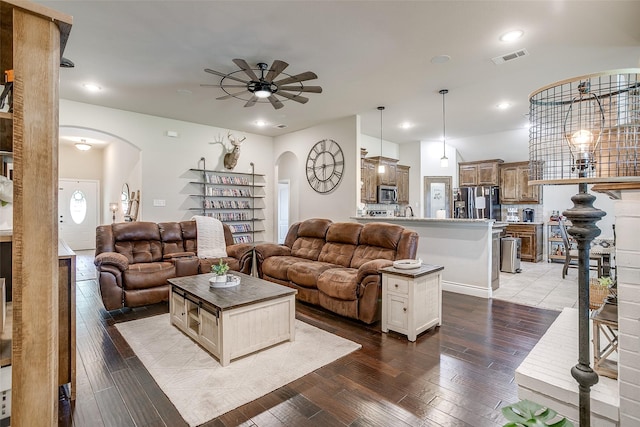 living room with recessed lighting, ceiling fan, visible vents, arched walkways, and hardwood / wood-style flooring