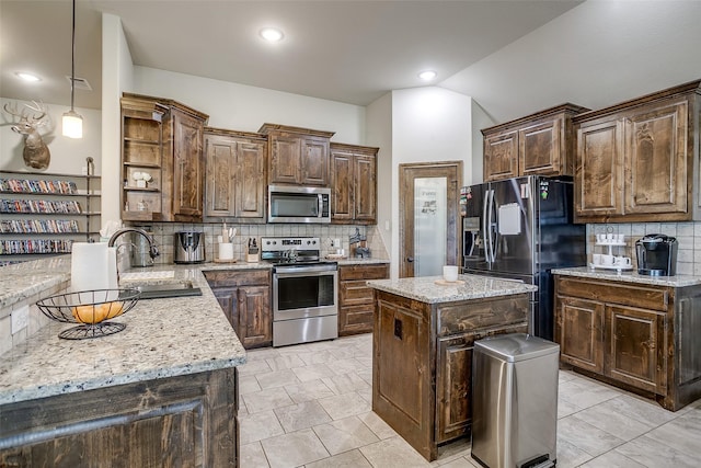 kitchen with backsplash, stainless steel appliances, open shelves, and a sink