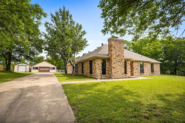 view of front of home with an outdoor structure, brick siding, a shingled roof, a garage, and a front yard