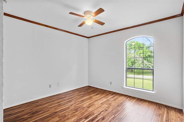 spare room featuring ornamental molding, a wealth of natural light, wood finished floors, and ceiling fan