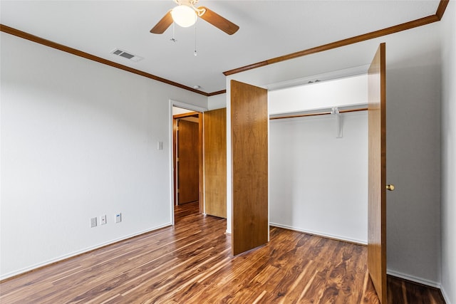 unfurnished bedroom with visible vents, ceiling fan, a closet, ornamental molding, and wood finished floors
