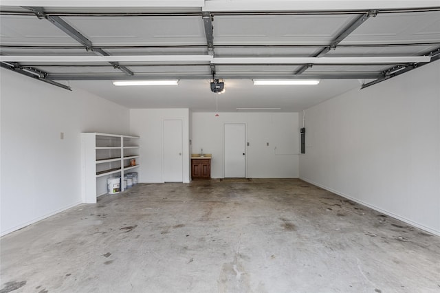 garage featuring electric panel and a garage door opener