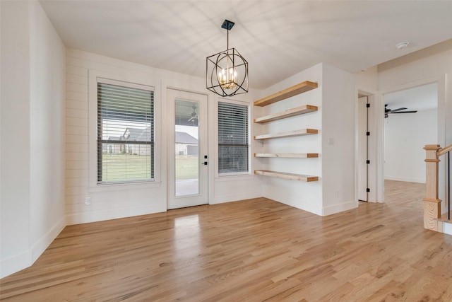 1001 Devoss Ct, Caddo Mills, TX 75135 - unfurnished dining area featuring baseboards, a notable chandelier, and light wood-style flooring
