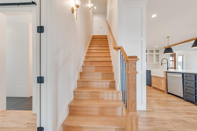 stairs with recessed lighting and wood finished floors