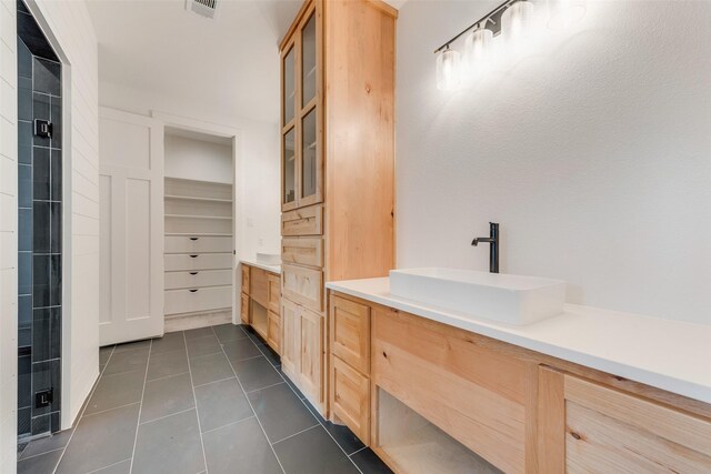 bathroom featuring vanity, walk in shower, tile patterned floors, and visible vents