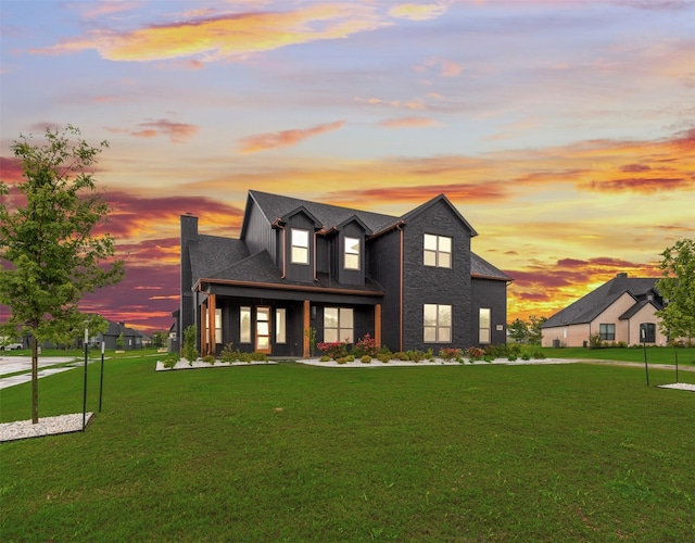 modern farmhouse with a lawn, board and batten siding, and a chimney