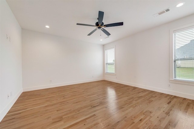 spare room with ceiling fan, visible vents, baseboards, light wood-style floors, and recessed lighting