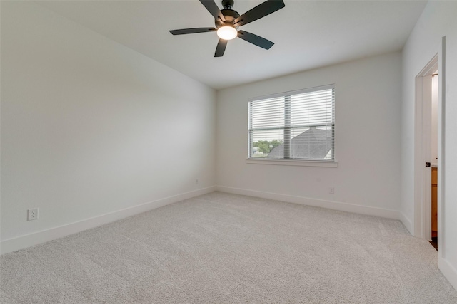unfurnished room featuring baseboards, ceiling fan, and light carpet