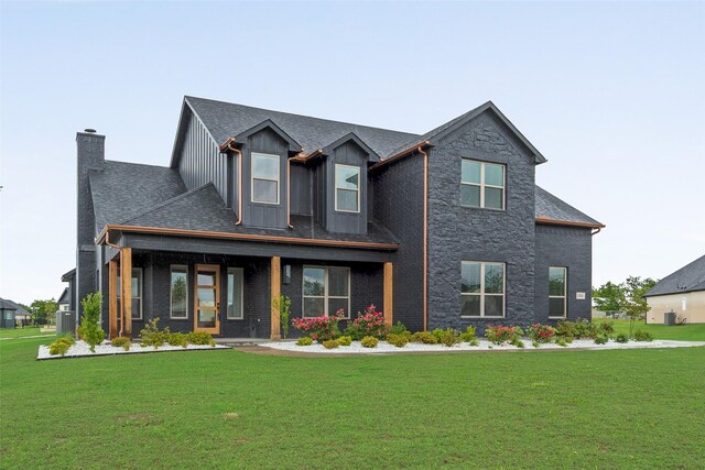 1001 Devoss Ct, Caddo Mills, TX 75135 - view of front of home featuring a front yard, covered porch, board and batten siding, and a chimney