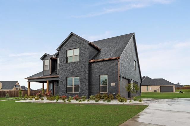 view of front of home featuring fence, stone siding, and a front lawn